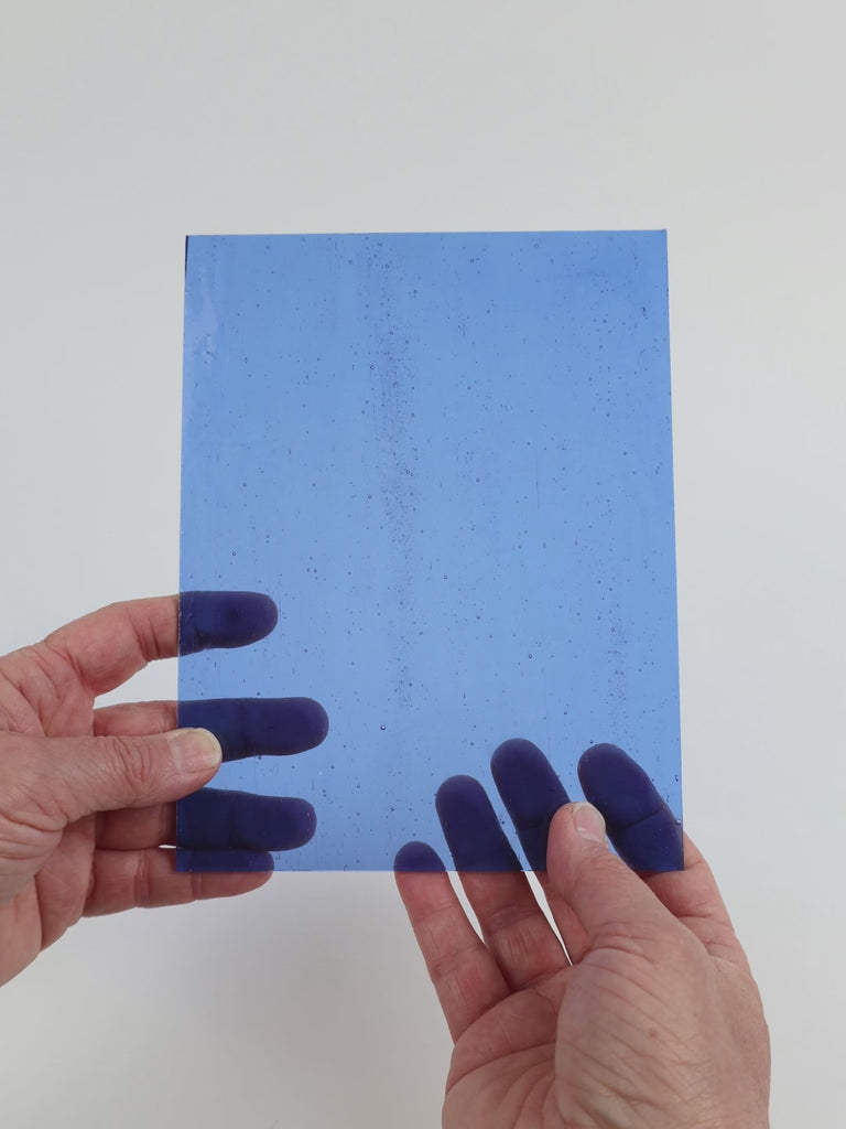 Video of the Mid Blue glass plate in transparent blue, 15x19cm, held up and tilted to show its pattern and transparency
