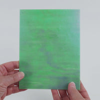 Video of the Pistachio Ice glass plate in iridised translucent teal, 15x19cm, held up and tilted to show its pattern and transparency