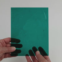 Video of the Deep Teal glass plate in transparent teal, 15x19cm, held up and tilted to show its pattern and transparency