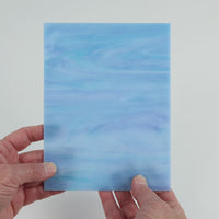 Video of the Soft Blue Opal glass plate in translucent blue, 15x19cm, held up and tilted to show its pattern and transparency