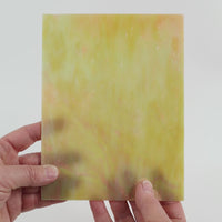Video of the marzipan glass plate in camel translucent iridescent, 15x19cm, held up and tilted to show its pattern and transparency