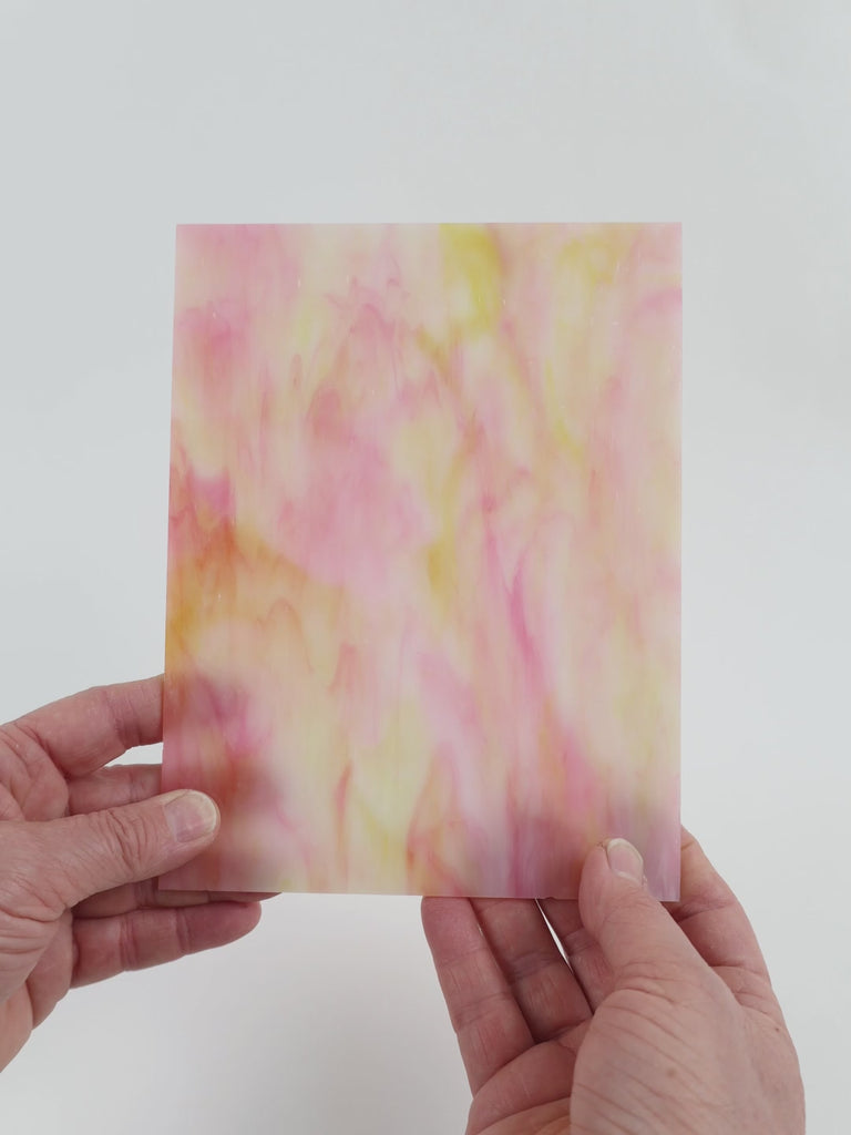 Video of the Pink Lemon Marble glass plate in translucent pink, 15x19cm, held up and tilted to show its pattern and transparency