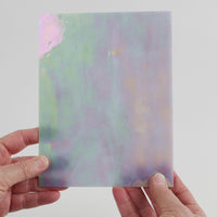 Video of the silver star opal glass plate in silver iridescent translucent, 15x19cm, held up and tilted to show its pattern and transparency
