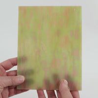 Video of the maple syrup glass plate in brown translucent iridescent, 15x19cm, held up and tilted to show its pattern and transparency