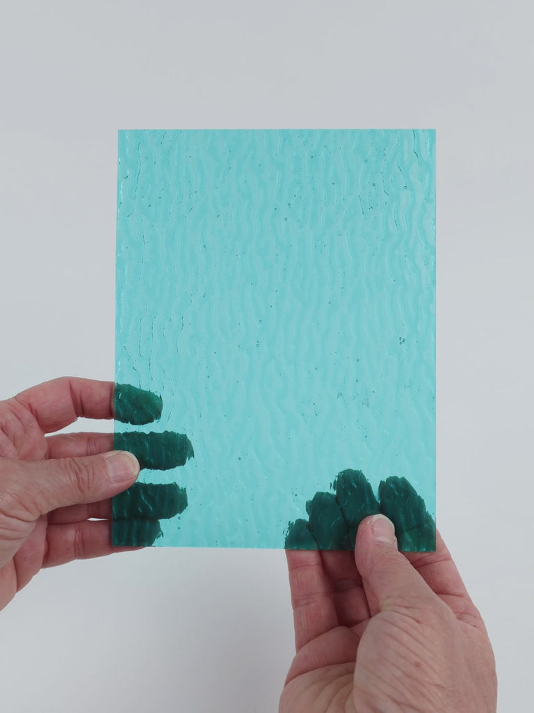 Video of the pale Turquoise Ripple glass plate in ripple transparent turquoise, 15x19cm, held up and tilted to show its pattern and transparency