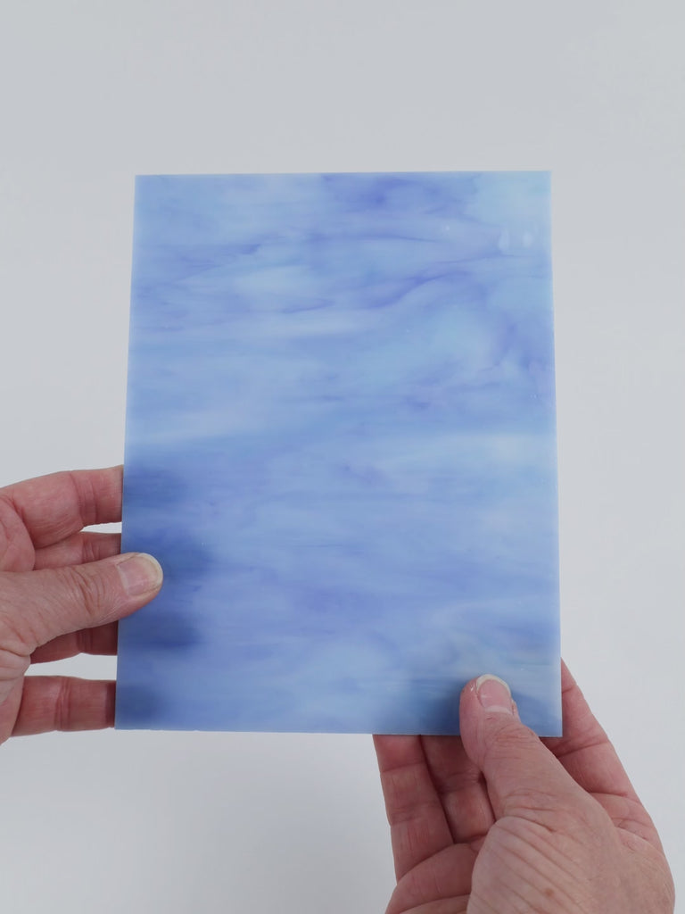 Video of the Current glass plate in translucent blue, 15x19cm, held up and tilted to show its pattern and transparency
