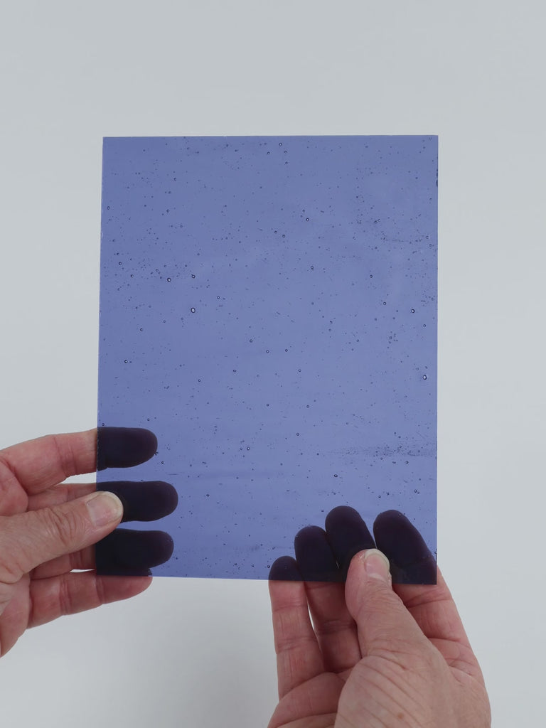 Video of the Periwinkle Cathedral glass plate in transparent purple, 15x19cm, held up and tilted to show its pattern and transparency